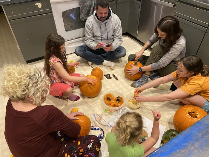 Tara Vancil and her family carving pumpkins